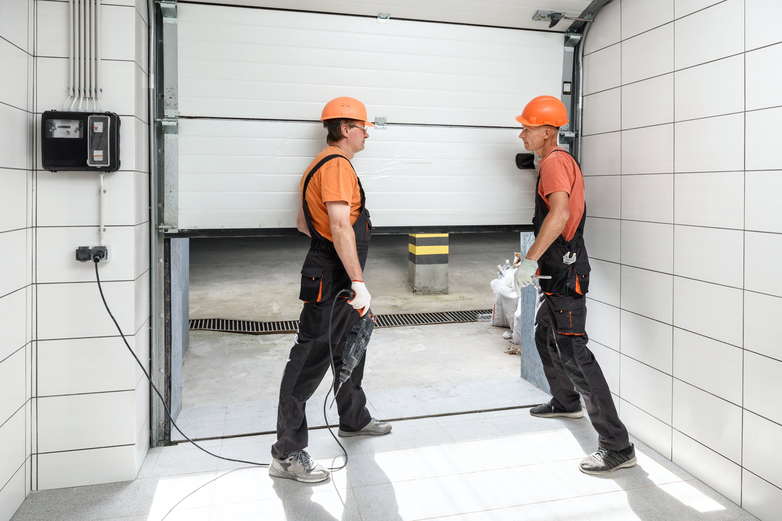 Workers are installing lift gates in the garage.